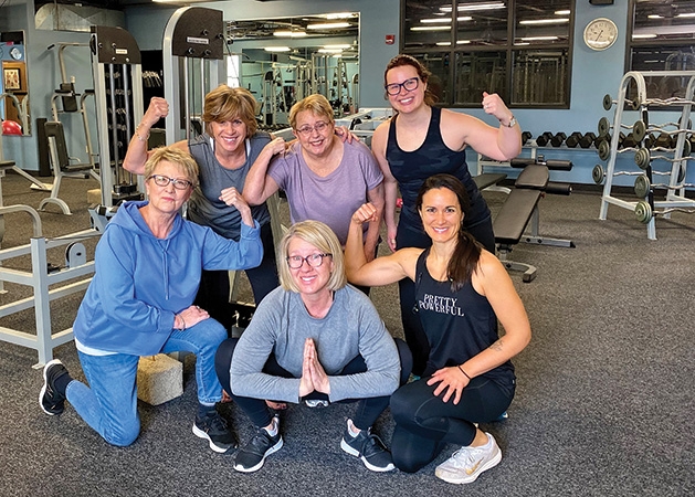 A group of women pose after working out.