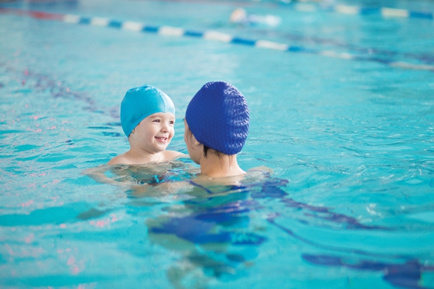 Mother and child swimming in a pool.