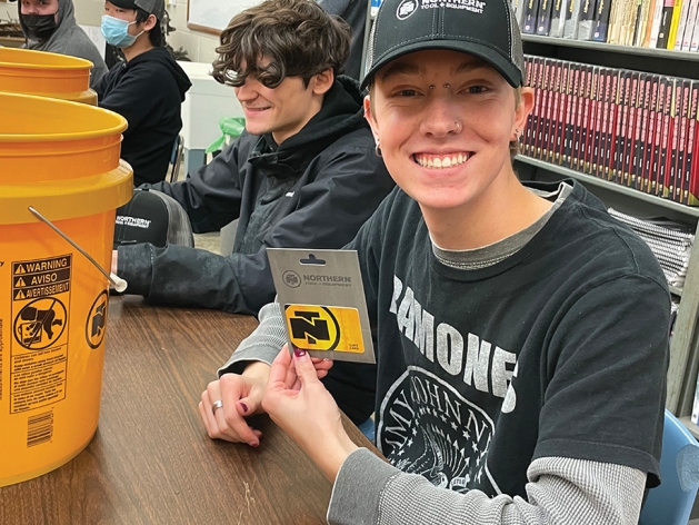 Woodbury High School Students with donated gift cards from Northern Tool + Equipment .