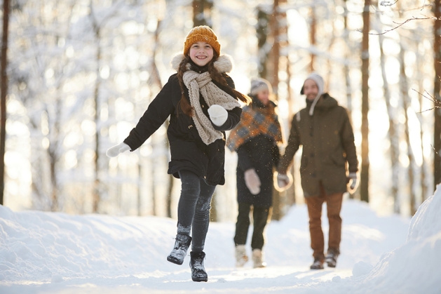 Family walking in winter woods.