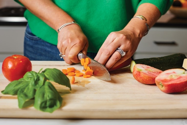 Molli Pletcher chopping vegetables. 