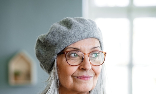 Woman with gray hair wearing gray beret.