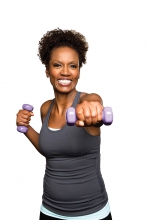 A woman lifts weights.