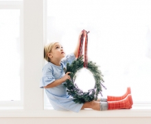 A child holds a wreath in this Focus on Woodbury photo contest winner.