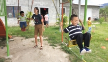 A volunteer with Woodbury nonprofit Milk and Honey Missions pushes children from the Honduran village of Villa San Antonio on a swing.