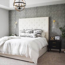 A bedroom with temporary wallpaper on the walls.