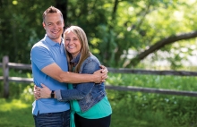 John Pohl and Krissy Wendell-Pohl hug each other.