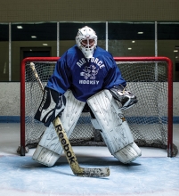 70-year-old goalie Kim Newman stands in net.