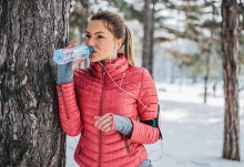 A woman drinks water to keep her hair, skin and body healthy during winter.