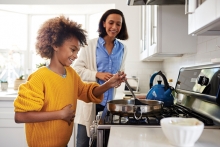 Kid helping cook in the kitchen.