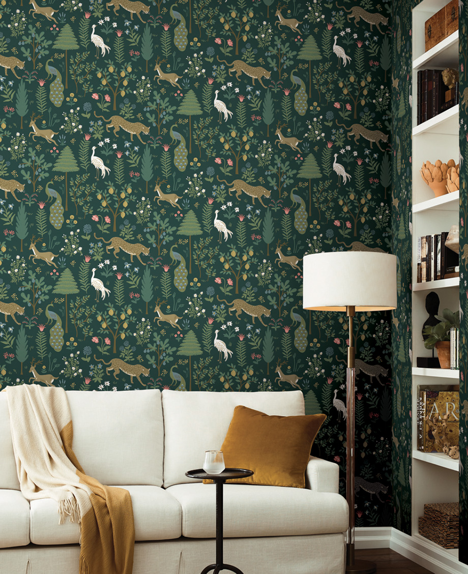 Woodland patterned wallpaper with a dark green background.
