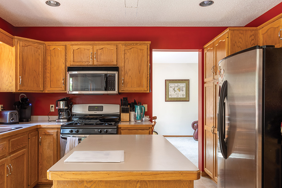 Kitchen before renovation with red walls.