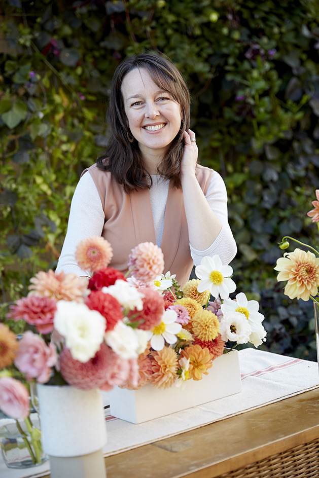 Floral designer Ashley Fox poses with some flowers.