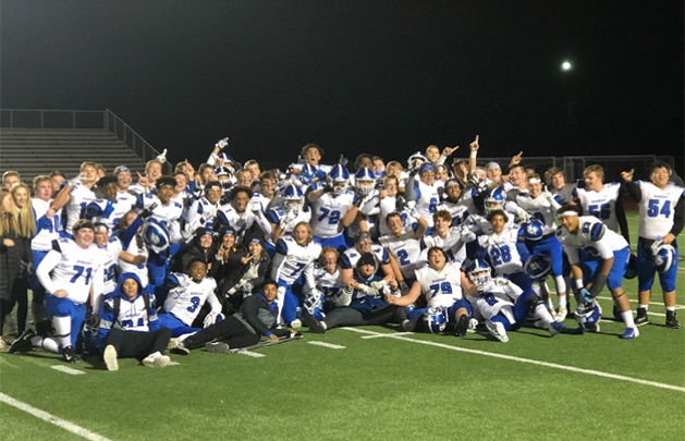 The Woodbury High School football team poses on the field.