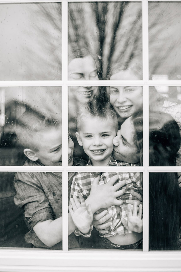 A family portrait taken through a window.
