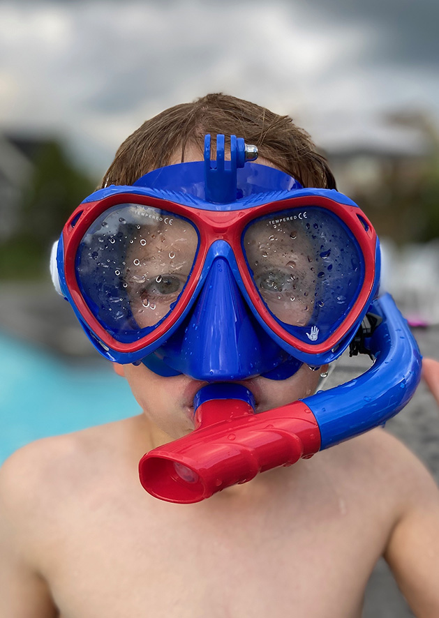 A kid wearing a scuba mask.