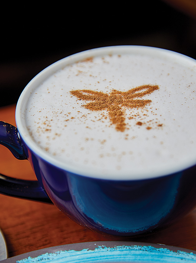 A coffee drink with dragonfly foam art from Lake Elmo Coffee