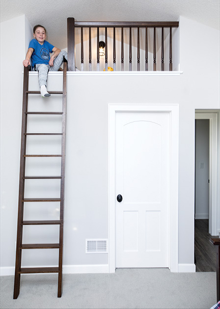 Sawyer Rippentrop sits on his loft bed in his Woodbury home.