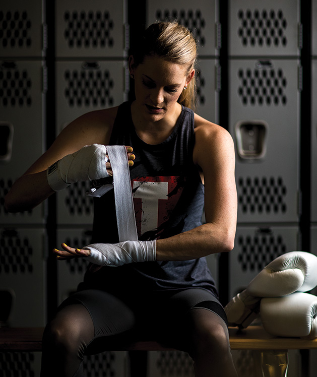 Sarah Krotz wraps her hands before kickboxing at TITLE Boxing Club Woodbury